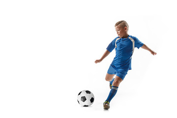 Young boy with soccer ball doing flying kick, isolated on white. football soccer players in motion on studio background. Fit jumping boy in action, jump, movement at game.
