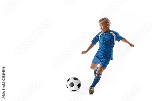 Young boy with soccer ball doing flying kick, isolated on white. football soccer players in motion on studio background. Fit jumping boy in action, jump, movement at game. photo