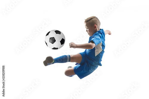 Young boy with soccer ball doing flying kick, isolated on white. football soccer players in motion on studio background. Fit jumping boy in action, jump, movement at game.