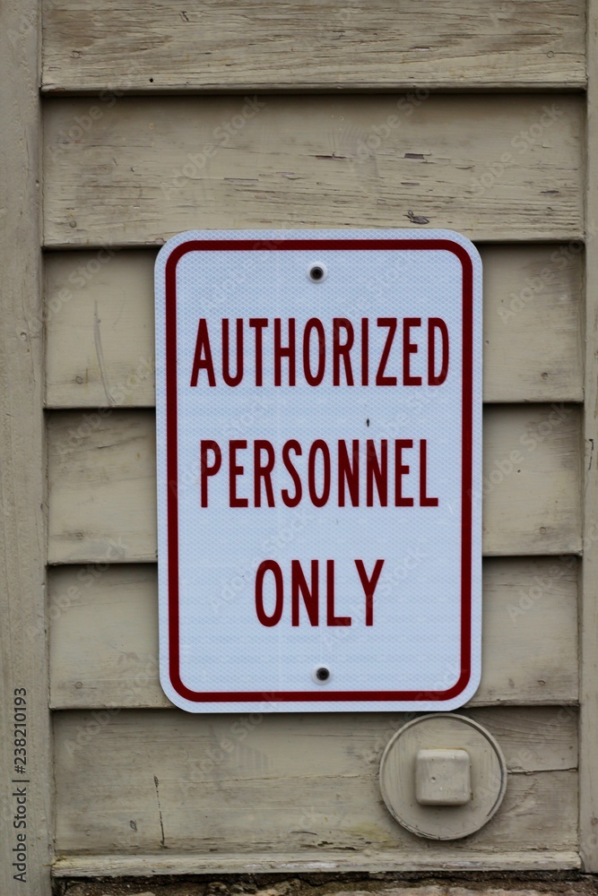 A close view on the red and white sign on the wall. A close view on the red and white sign on the wall.