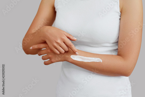 Wallpaper Mural Closeup shot of woman hands holding cream and applying moisturizing hand cream. Beautiful female hands with cream. Hand Skin Care. A woman uses body lotion on your arms. Beauty And Body Care Concept Torontodigital.ca