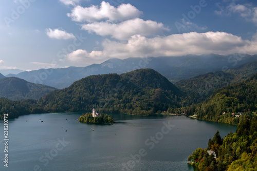 Slovenia - Aerial view of the beautiful mountain lake Bled . Pilgrimage Church of the Assumption of Maria situated on an island . Mountains in background. European travel.