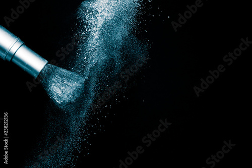 Deep ocean powder color splash and silver brush for makeup artist or beauty blogger in black background, look like a look like a cold and calm mood.