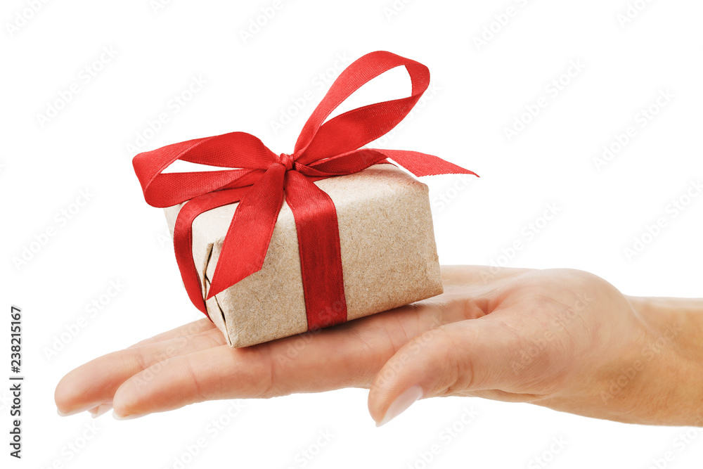Gift in hand isolated on white background. Festive closeup concept Gift in hand isolated on white background. Festive closeup concept