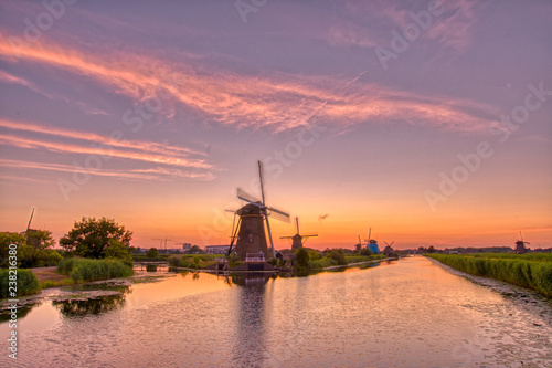 view of traditional windmills at sunset in Kinderdijk, The Netherlands.