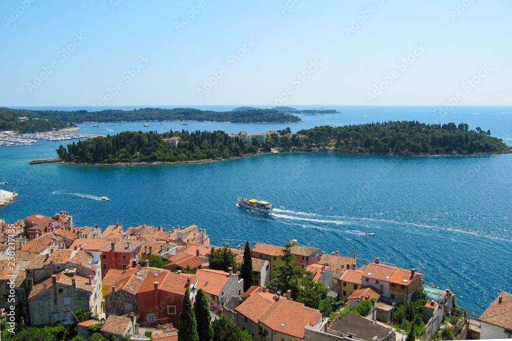 Beautiful view of the ancient city, the island and the sea on which the ship sails. Rovinj, Istria, Croatia. Aerial shot.