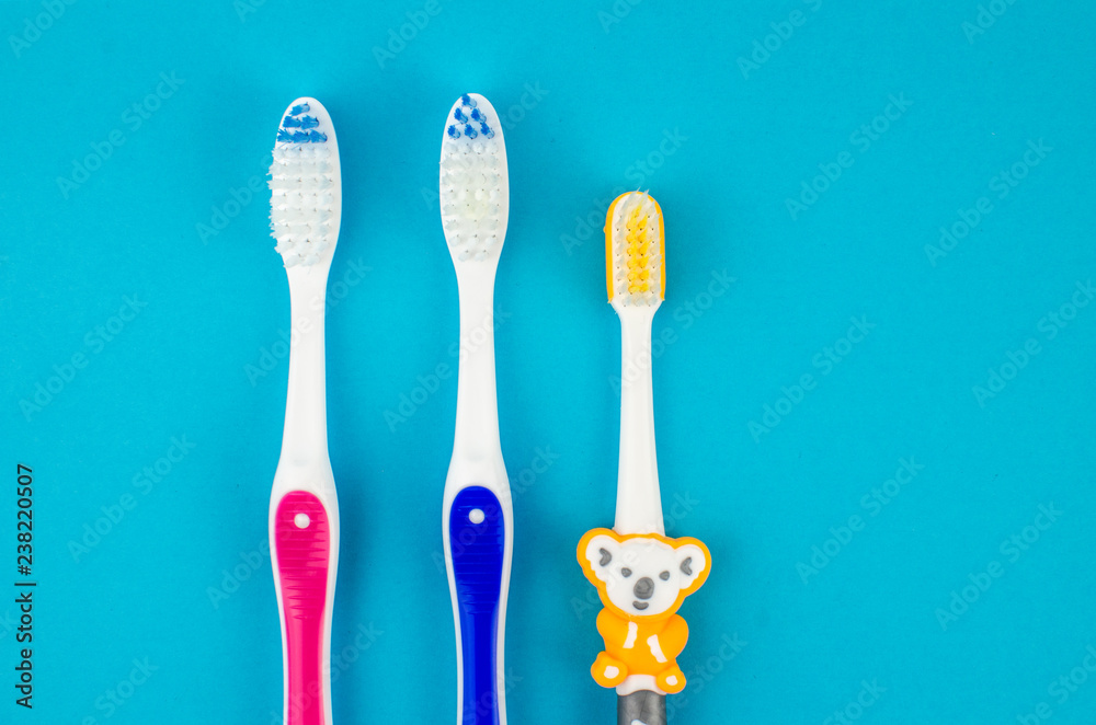 Toothbrushes on blue background. Copy space for text Toothbrushes on blue background. Copy space for text