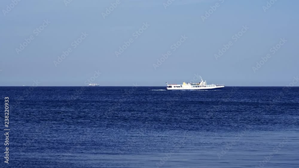 Beautiful sunny landscape with white yacht on sea skyline and blue sky background. Tourist cruise ship sailing on clear water horizon to harbor. Marine vacation, navigation panorama with sail boat. Beautiful sunny landscape with white yacht on sea skyline and blue sky background. Tourist cruise ship sailing on clear water horizon to harbor. Marine vacation, navigation panorama with sail boat.