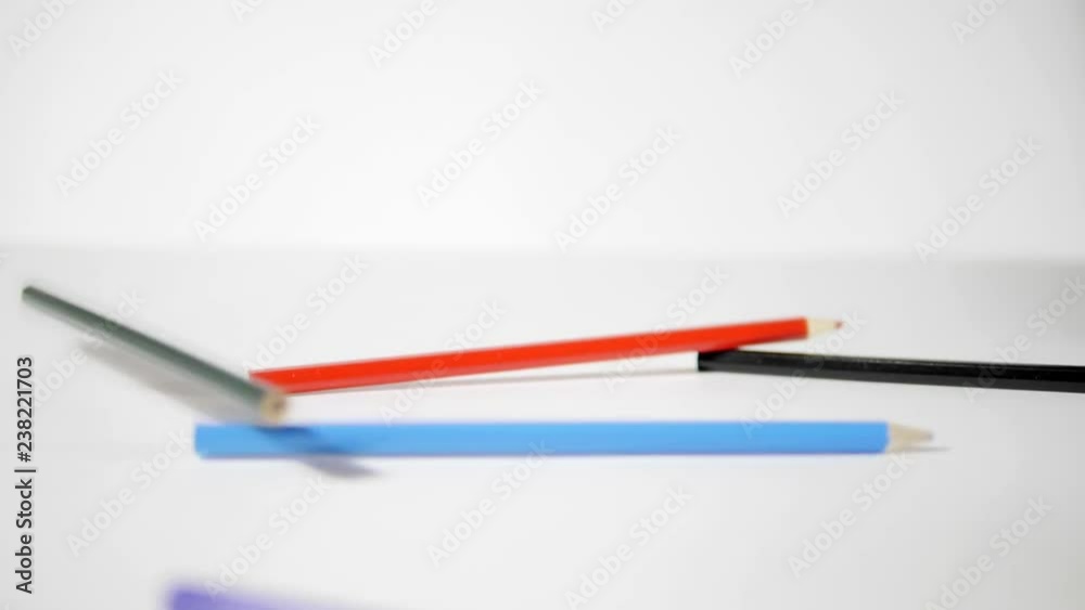 Pencil on a white background. Colouring pencils falling on white background in slow motion Pencil on a white background. Colouring pencils falling on white background in slow motion