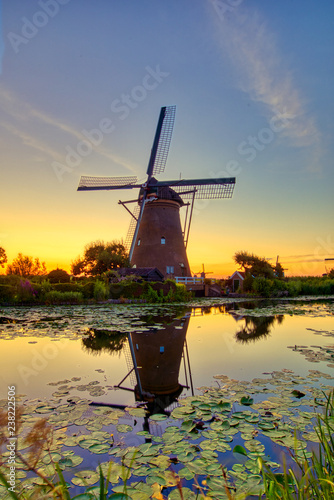 view of traditional windmills at sunset in Kinderdijk, The Netherlands.