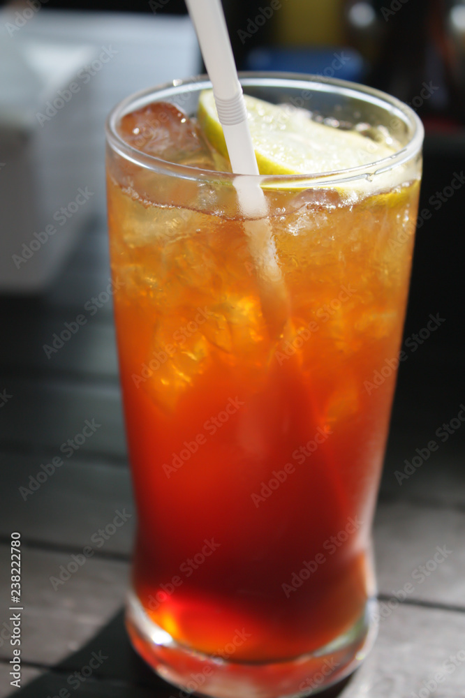 Close up glass of lemon tea. And ice Located on the wooden table. Close up glass of lemon tea. And ice Located on the wooden table.