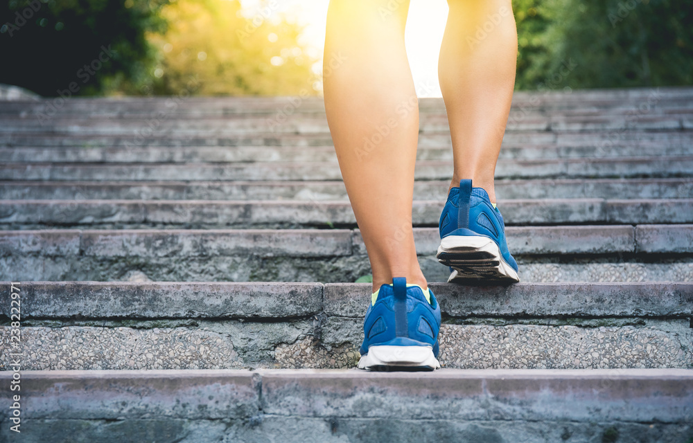 Fitness woman running up the old stairs. Legs running and burn out fat for fit body, Healthy and lifestyle concept poster Fitness woman running up the old stairs. Legs running and burn out fat for fit body, Healthy and lifestyle concept poster