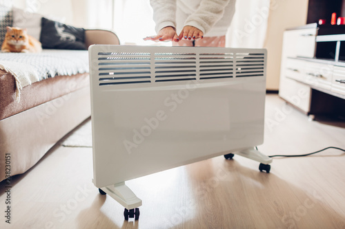 Obraz na płótnie Using heater at home in winter
