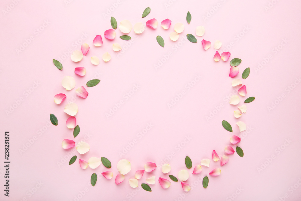 Rose petal flowers and green leafs on pink background