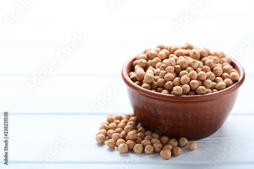 Chickpeas in bowl on wooden table