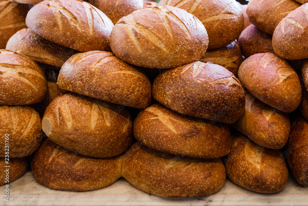 Fresh sourdough bread stacked in a bakery ready to sell and eat Fresh sourdough bread stacked in a bakery ready to sell and eat