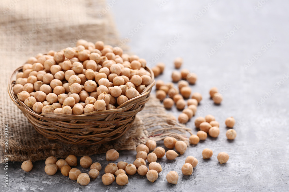 Chickpeas in basket on grey wooden table Chickpeas in basket on grey wooden table