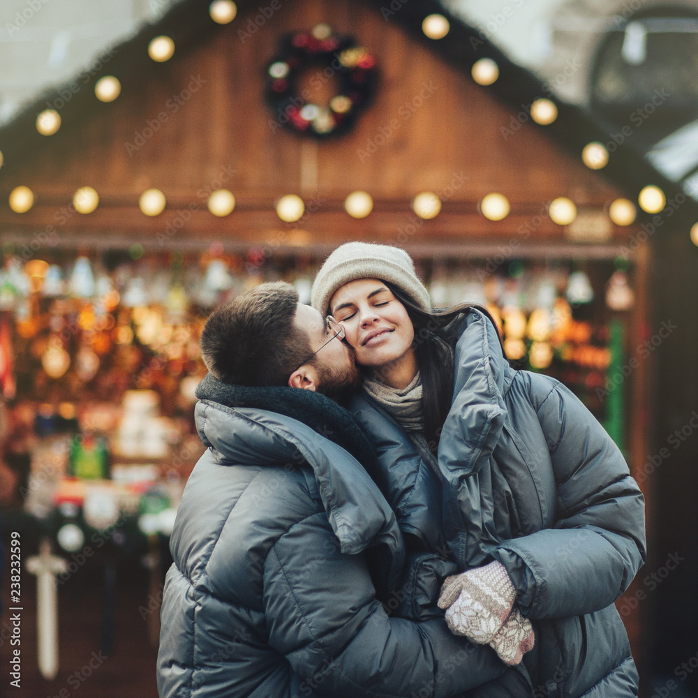 Winter holidays. Young beautiful happy smiling couple posing on   
