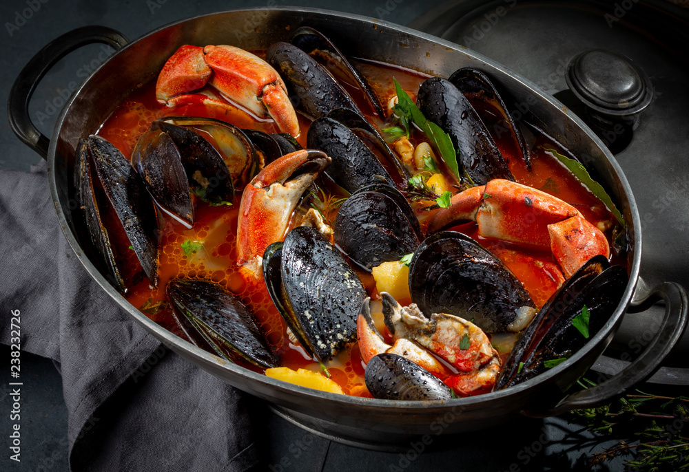 Seafood soup with mussels and crabs in metal pot Seafood soup with mussels and crabs in metal pot