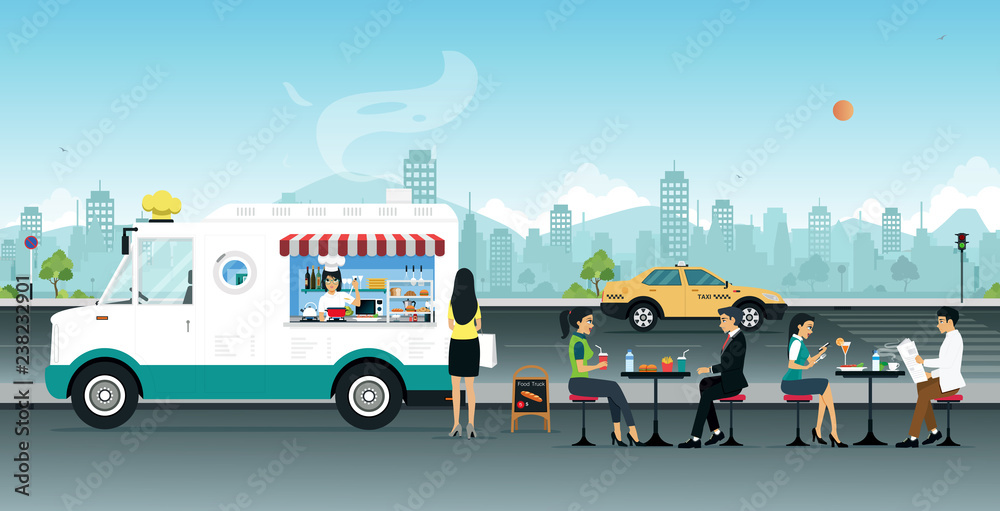 Food trucks sell to people sitting on the street.