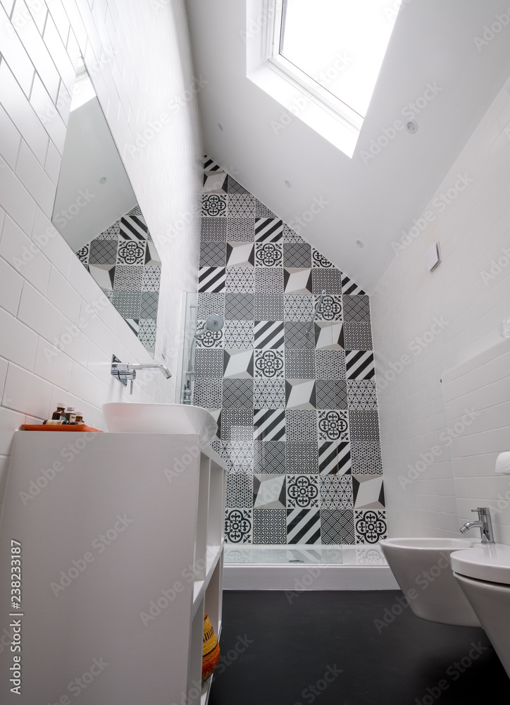 Modern loft bathroom with high ceiling in eaves, walk in shower and monochrome black and white