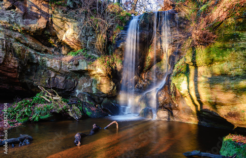 Roughting Linn Waterfall at Routin Lynn, which is well hidden in remote woodland, located in northern Northumberland, England and is also known as Routin Lynn Waterfall