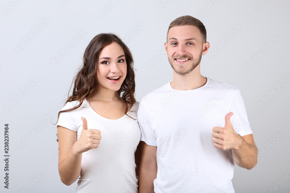 Happy young couple on grey background Happy young couple on grey background