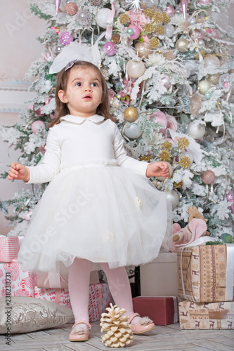Little child girl and Christmas tree