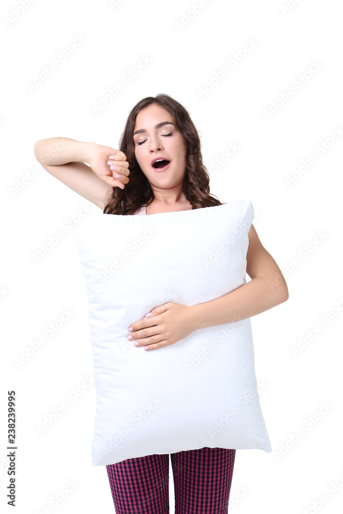 Yawning girl holding pillow isolated on white background Yawning girl holding pillow isolated on white background