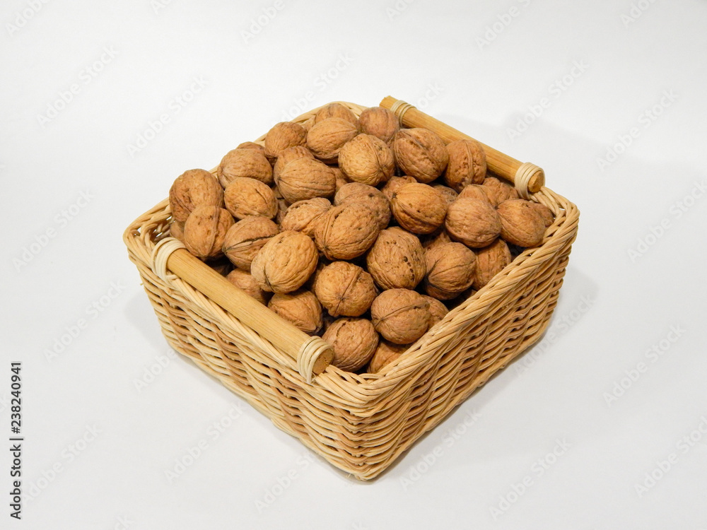 Walnuts in a basket on a white background Walnuts in a basket on a white background