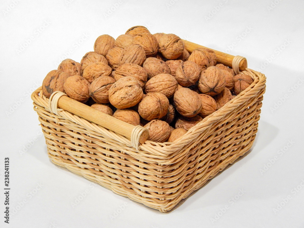 Walnuts in a basket on a white background Walnuts in a basket on a white background