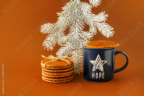 Dutch waffle stroopwafel background cookies round brown pastries blue cup coffee tea hope star christmas tree white yellow photo