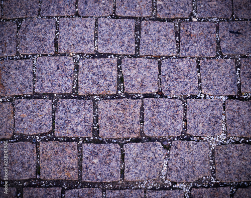 gray cobblestone tiled sidewalk pavement with vignette. background, texture.