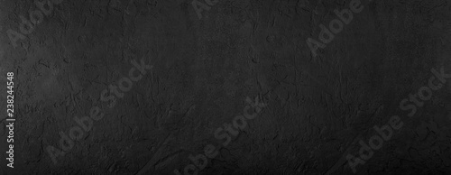 Black stone background, grey cement texture. Top view, flat lay