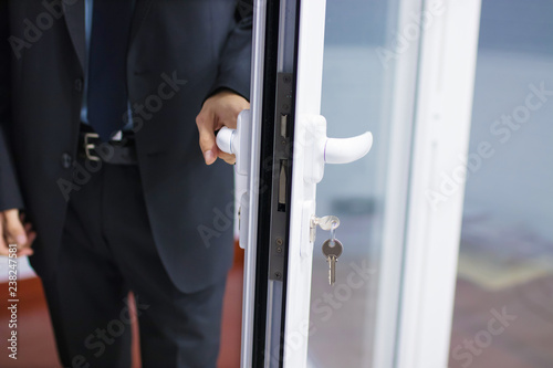 Valokuva hand at the entrance door or access, lock and security