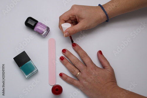 Manicurist painting nails