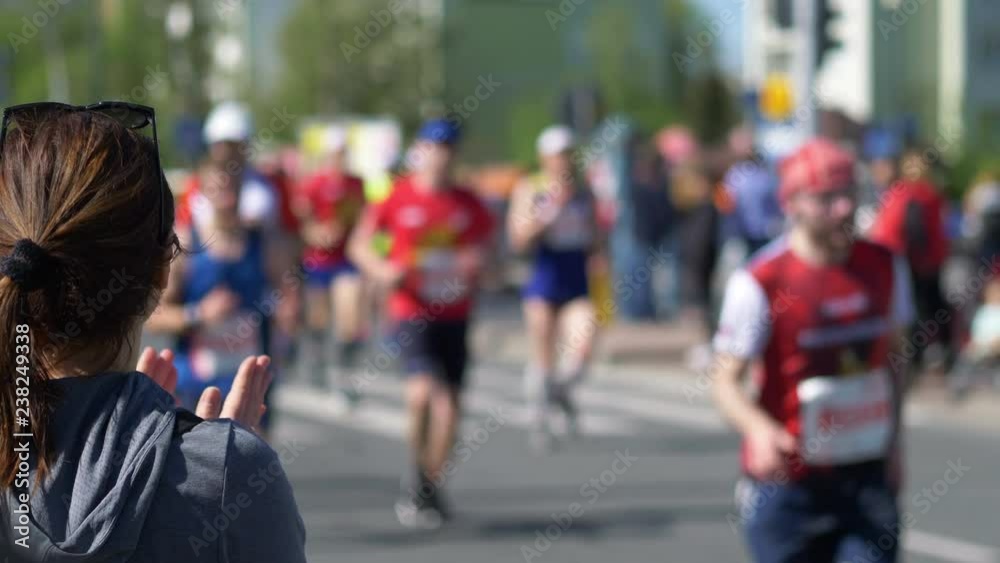 Woman cheering runners and clapping hands in 4k slow motion 60fps Woman cheering runners and clapping hands in 4k slow motion 60fps