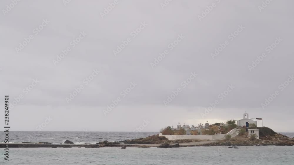 Greece destinations. Chapel and cemetery on sea shore in Agios Fokas near Monemvasia, dark overcast sky. Laconia region Peloponnese. Time lapse 4K Greece destinations. Chapel and cemetery on sea shore in Agios Fokas near Monemvasia, dark overcast sky. Laconia region Peloponnese. Time lapse 4K