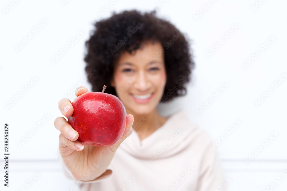 Close up smiling woman holding red apple Close up smiling woman holding red apple