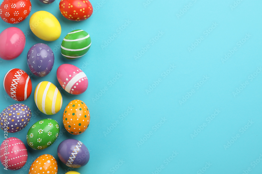 Decorated Easter eggs and space for text on color background, top view Decorated Easter eggs and space for text on color background, top view