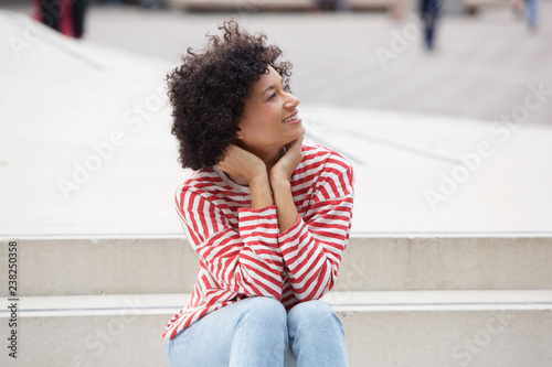 attractive older woman sitting outdoors on steps