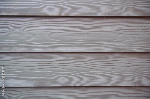 The texture of a wooden wall with horizontal stripes of grey or silver boards, background