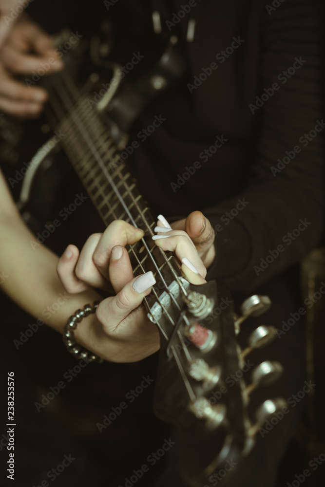 Feeling the music. Male and female hands play the electric guitar. Couple  of guitar players. Couple of musicians enjoy playing music. Couple in love  play duets. Instrumental music live Stock-Foto | Adobe
