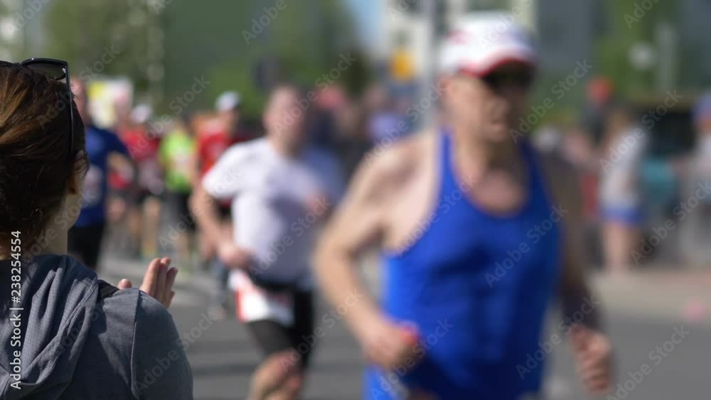 Woman cheering runners and clapping hands in 4k slow motion 60fps Woman cheering runners and clapping hands in 4k slow motion 60fps