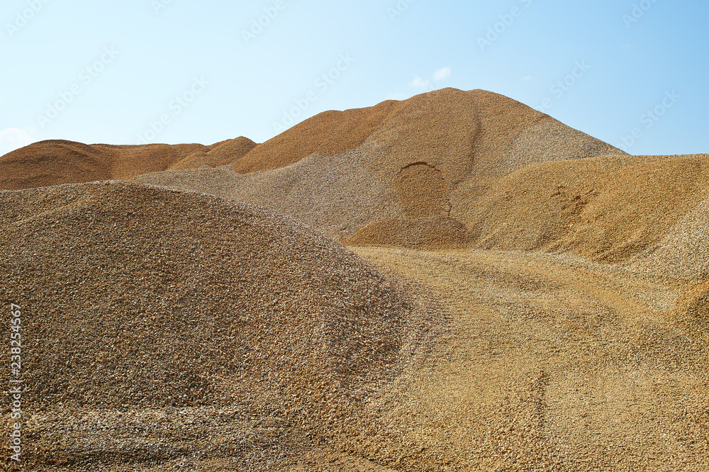 Heaps of sand or macadame and road in a quarry Heaps of sand or macadame and road in a quarry