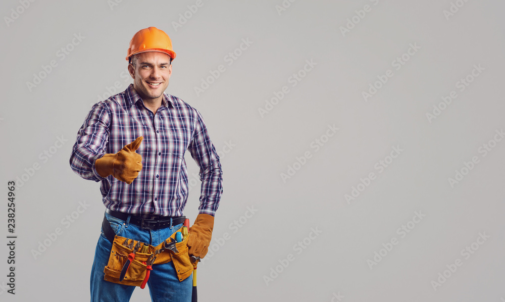 Repairman smiling in special clothes with tools. Repairman smiling in special clothes with tools.