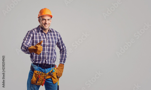 Repairman smiling in special clothes with tools.