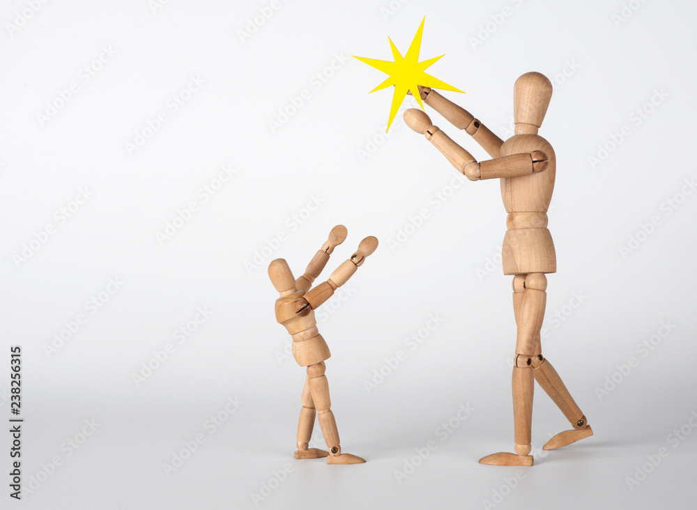 Christmas story. Two little wooden men with the shining star of Bethlehem. Christmas story. Two little wooden men with the shining star of Bethlehem.
