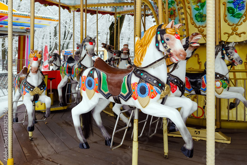 Carousel with rocking horses in the park. Children's carousel is closed for the winter season. horses.