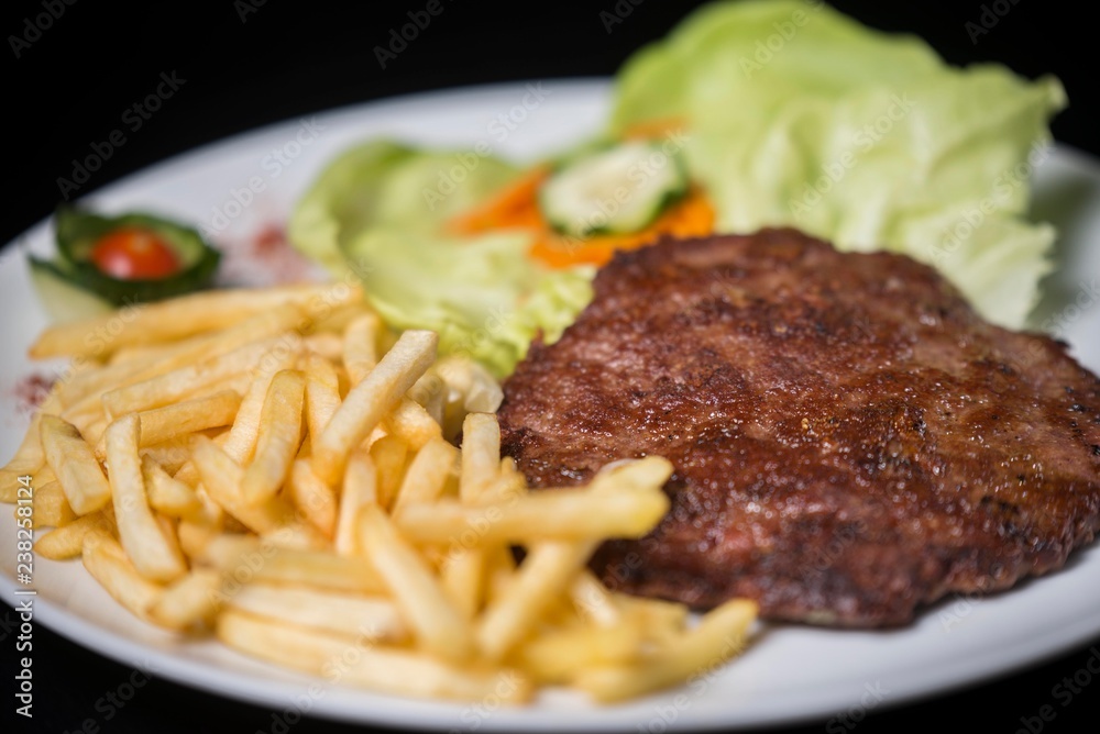hamburger with french fries isolated on plate. hamburger with french fries isolated on plate.